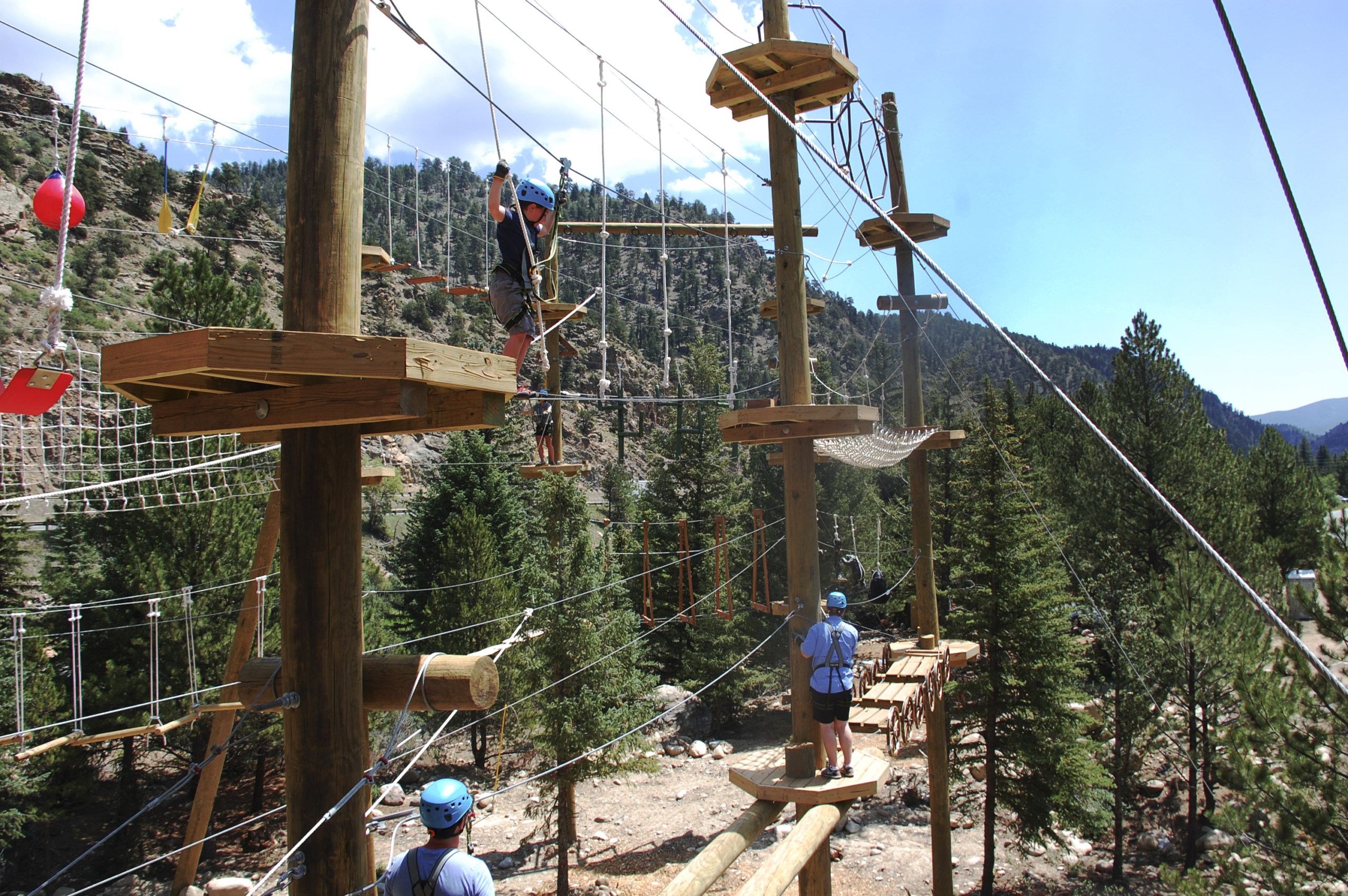 boy climbing aerial park at sky trek in colorado at adventure center