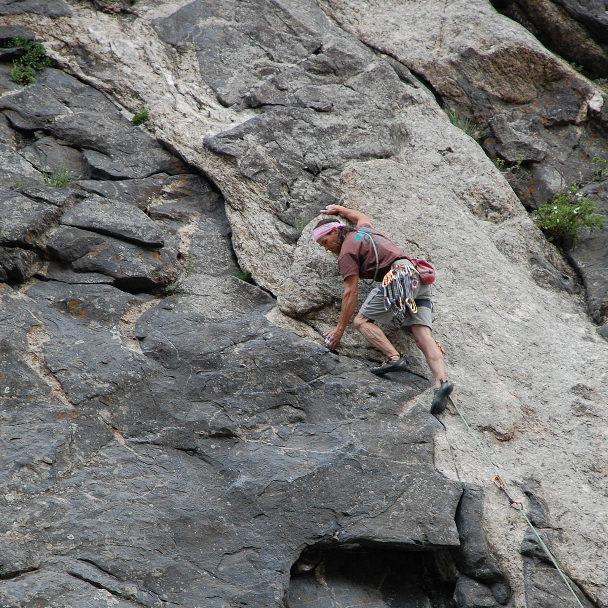 Rock climber scales a cliff.