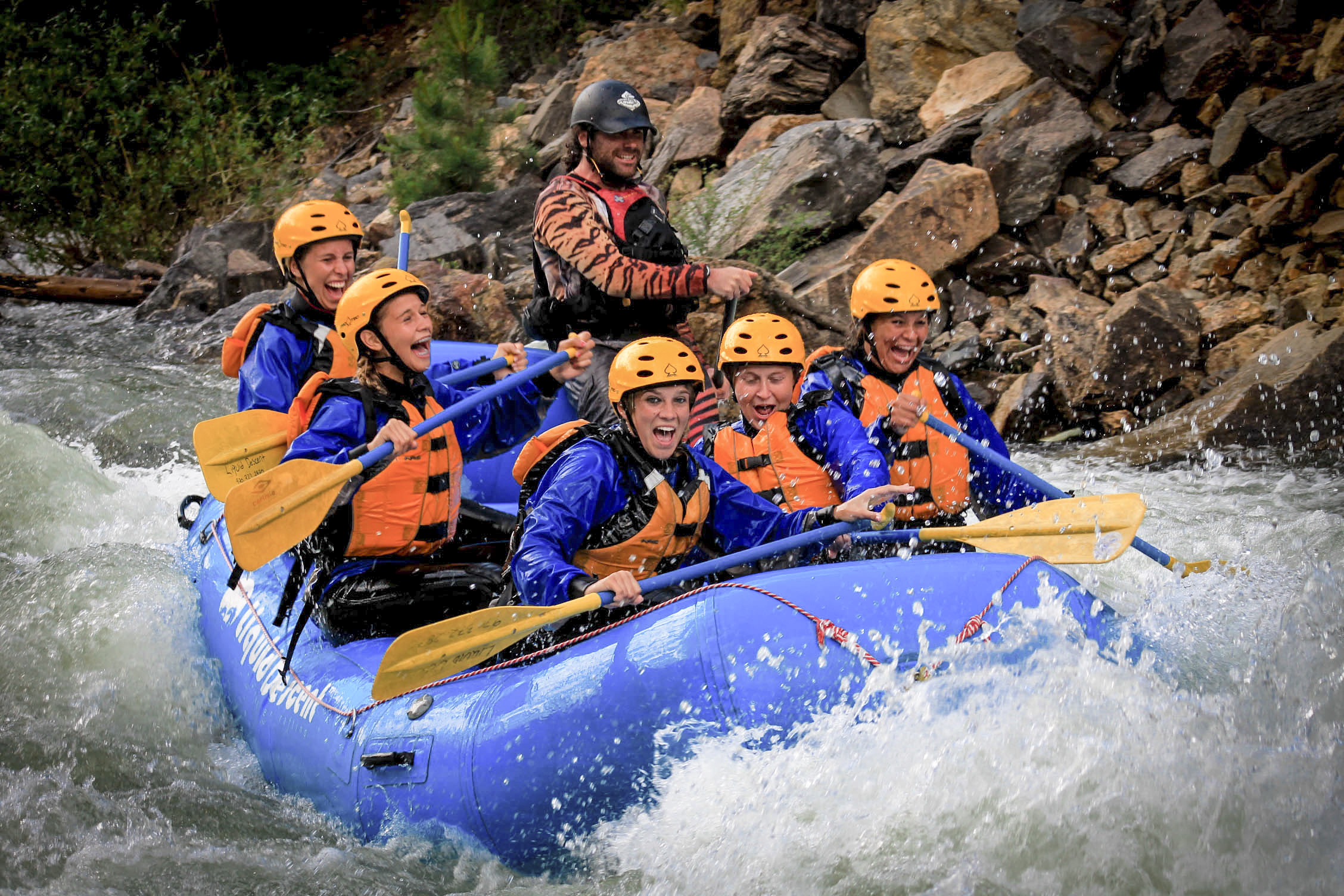Rafters brace themselves in heavy rapids.