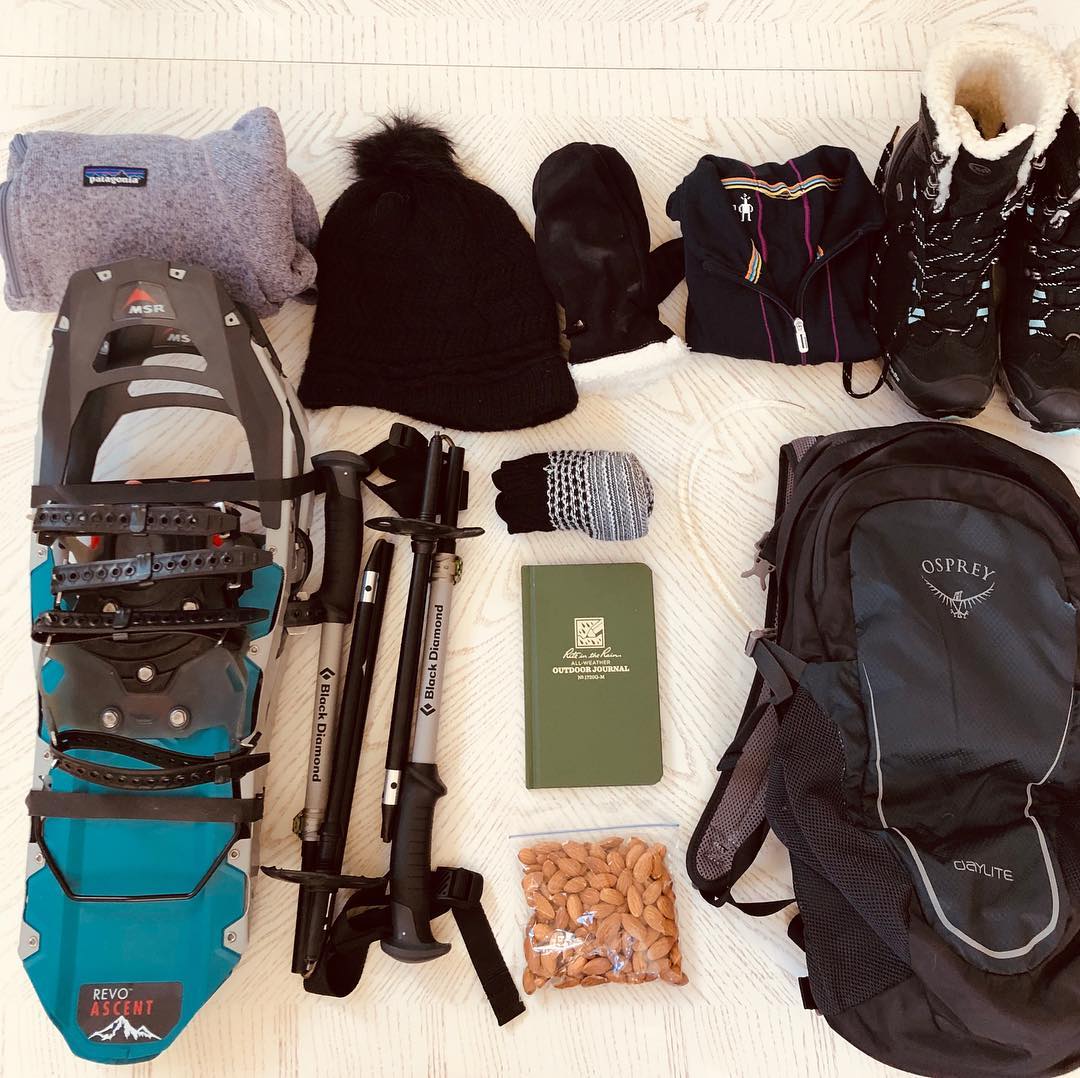 a line of gear and snowshoes packed for a trip