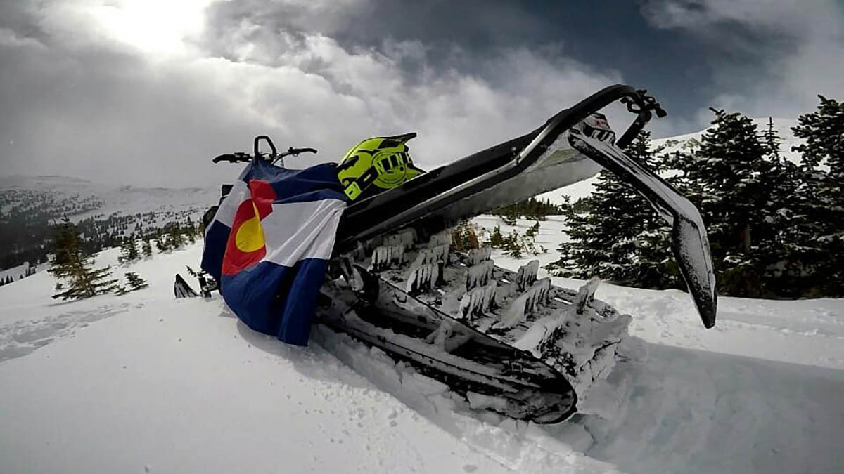 Snowmobile with Colorado flag.
