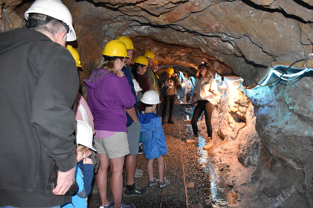 Historic mine tour with a group wearing hard hats.