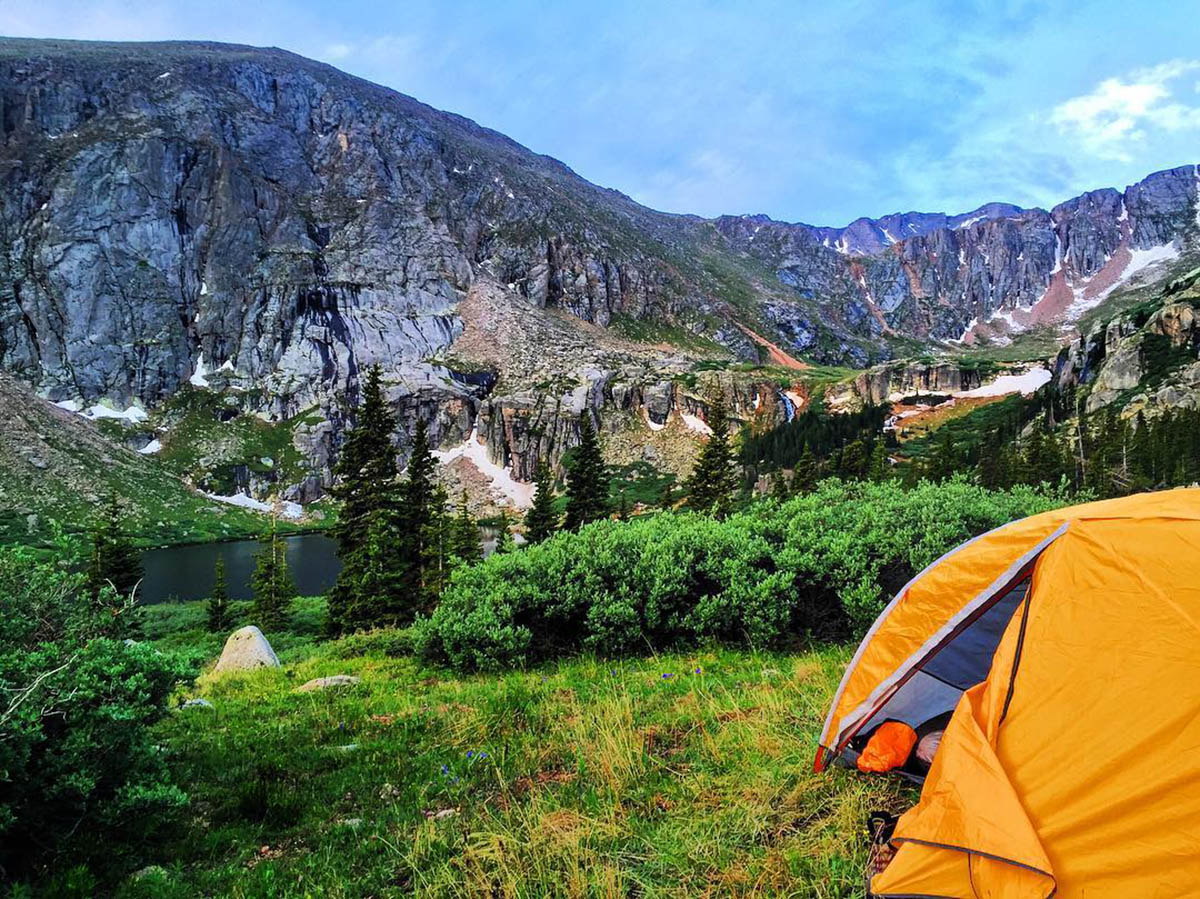 Tent opens to a colorful mountain valley below.